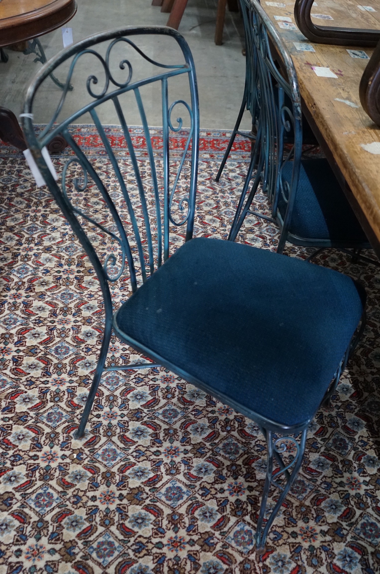 A set of four painted wrought iron dining chairs
